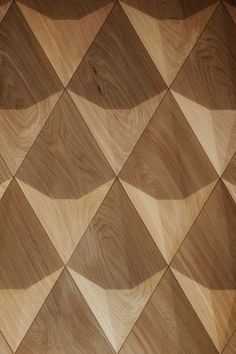 a wooden wall with many different shapes and sizes on it's sides, as well as wood flooring