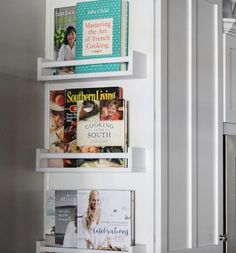 three white shelves with magazines on them