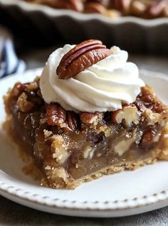 a slice of pecan pie with whipped cream on top