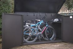 two bikes are parked in the back of a metal box