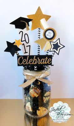 a jar filled with chocolates and graduation decorations