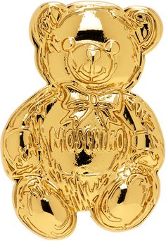 Brooch in gold-tone brass. · Logo and graphic at face · Safety-pin fastening · H1.25 x W0.75 Supplier color: Shiny gold Moschino Bear, Swarovski Teddy Bear Necklace, Teddy Bear Necklace Gold, Moschino Toy 2, Moschino Teddy Bear Bag, Moschino Teddy Bear, Jewelry Pins, Safety Pin, Moschino