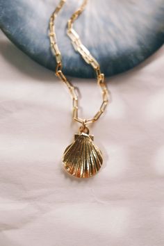 A beachy addition to your gold necklace collection, this stunning Gold Scallop Shell Necklace will be your new favorite layering staple. Inspired by the ocean's treasures and our endless summers, these will bring the aloha breeze straight to your doorstep.✦ DETAILS ✦✧ Name: Hoaka (ho AH kah) - brightness, to glitter.✧ 18kt Gold filled chain.✧ 24kt Gold Plated over Brass Shell Pendant measures 23mm x 18mm.✧ All Ke Aloha Jewelry pieces come packaged thoughtfully, beautifully, and ready for gift giving.✧ Unless otherwise noted in the listing description, all pieces are sold individually. Photos with models/multiple pieces are for style inspiration only. Hawaii Necklace, Brass Shell, Hawaii Jewelry, Scallop Shell, Necklace Collection, Seashell Necklace, Scallop Shells, Durga Goddess, Everyday Necklace