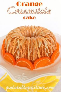 an orange creamsicle cake on a white plate with the words orange creamsicle cake above it