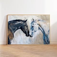 two horses standing next to each other in front of a painting on the wall with wood flooring