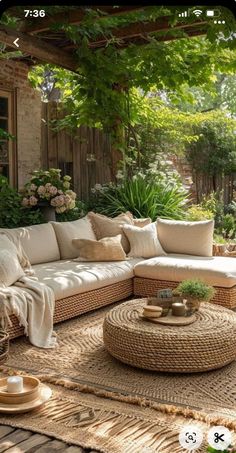 an outdoor living room with wicker furniture