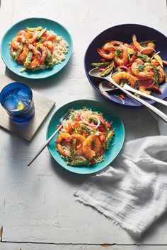 three plates of shrimp and rice with chopsticks next to them on a table