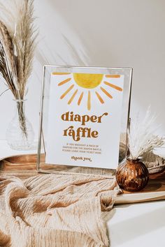 there is a sign that says diaper raffle next to some dried grass and a vase