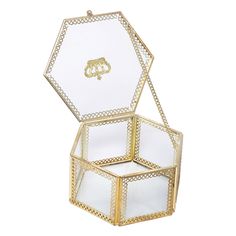 an open glass box with gold trimmings on the lid and bottom, sitting in front of a white background