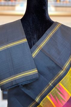 This unique kanjivaram saree is handwoven with checks in a multi shade of magenta, black, yellow and purple running along the body. The thazhambu reku korvai borders in black have fine bands and stripes in gold zari. The pallu mirrors the color of the borders and features a geometric band and stripes in gold zari.\ Approximate Length 6.5 mtrs (inclusive of blouse length) Approximate Height - 48 - 52" Approximate weight - 1.5 lbs Saree comes with fall, picot and tassels done when applicable. Blouse piece is cut. Kindly Note : The colors you see on your device may vary due to the color reproduction, brightness and resolution of individual devices. If you'd like more clarity before your purchase, please contact our support team. Kanjivaram Saree, Kanjivaram Silk Saree, Yellow And Purple, Silk Cotton Sarees, Kanjivaram Sarees, Cotton Sarees, Blouse Length, Support Team, Cotton Saree