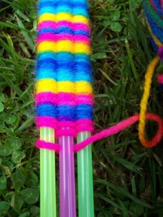 two multicolored plastic straws tied together in the grass