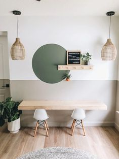 a dining room with white chairs and a wooden table