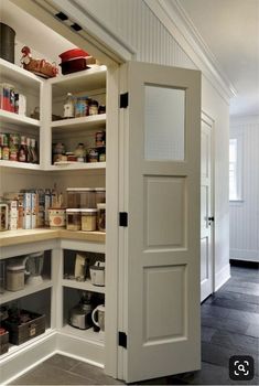 an open pantry door in the corner of a kitchen