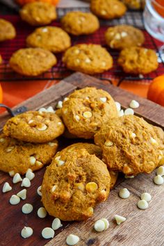 pumpkin cookies with white chocolate chips on a cutting board