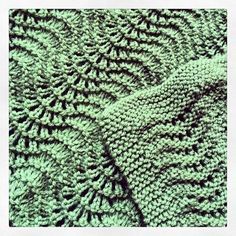 a green knitted blanket with leaves on it