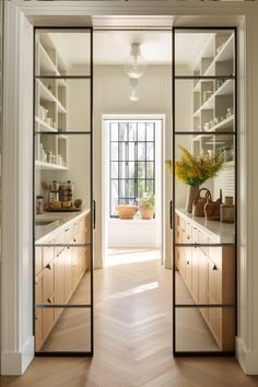 an open glass door leading to a kitchen