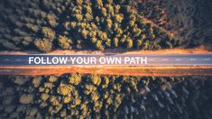 an aerial view of a road that has the words follow your own path on it