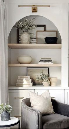 a living room filled with furniture and shelves