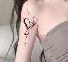 a woman with a heart tattoo on her arm