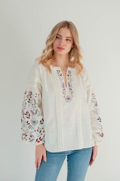 Loose fit floral linen embroidered blouse. Modern ukrainian vyshyvanka blouse. DESCRIPTION: ▪️ 100% linen ▪️ colorful stitch embroidery with floral motifs. ▪️ special detailing on a chest - small folds ▪️ long sleeves with cuff button 📍Please note that colors may vary a little from one monitor to another📍 Made from 100% linen, washed and softened before sewing. This item won`t shrink after washing at home. Every item is handmade to order and to your body measurements (custom size). Also, you c Ukrainian Blouse, Ukrainian Vyshyvanka, White Linen Blouse, Linen Wrap Dress, Ukrainian Dress, Embroidered Wedding Dress, Blouse Casual Fashion, Western Tops, Embroidered Sleeves