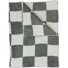 a gray and white checkered blanket on top of a bed