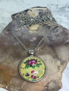 If you love vintage vibes, you'll love this beautiful floral cabochon pendant necklace.  This cabochon pendant necklace is made with gorgeous yellow, floral cotton fabric with a glass dome overlay. The dome glass sits in a silver tray pendant. It gives off such beautiful vintage vibes😍.  It hangs on a 25" stainless steel, non -tarnishing cable chain with a lobster claw clasp. It would make the perfect Mother's Day gift 💝. Vintage Flower-shaped Nickel-free Necklaces, Retro Necklaces With Lobster Clasp For Gifts, Retro Necklaces With Lobster Clasp As A Gift, Retro Necklace With Lobster Clasp As Gift, Handmade Retro Necklace, Handmade Retro Necklaces For Gifts, Retro Handmade Necklace For Gift, Handmade Retro Necklace For Gift, Vintage Yellow Round Pendant Jewelry