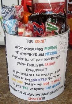 a bucket filled with candy and candies on top of a counter