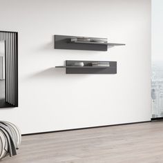 a white room with some black shelves on the wall