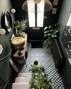 the hallway is decorated in black and white with lots of greenery on the floor