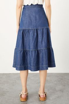 Proving that nothing beats a classic, this midi is cut from blue-wash denim. It makes a great jeans alternative, with a high waist, tiered shape and contrast stitching. Designed with a sustainable blend of eco-conscious cotton and hemp. Chambray Skirt Outfit, Jeans Alternative, Midi Denim Skirt, Crochet Waistcoat, Skirt Tiered, Chambray Skirt, Tiered Midi Skirt, Midi Denim, Laser Cut Leather