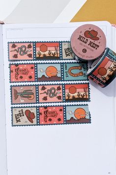 bobo design studio's wild west postage washi tape placed on a wanderlust passport travel journal