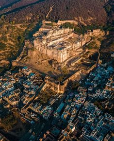 an aerial view of a large building in the middle of a city with lots of buildings