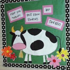 a bulletin board with a cow and flowers on it