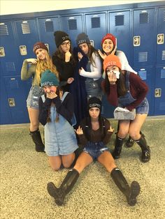 a group of young women standing next to each other in front of blue lockers