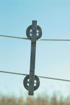 an image of a metal object hanging on a wire