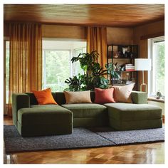 a living room filled with lots of furniture and plants on top of the windowsill