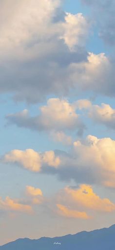 two airplanes are flying in the sky with mountains in the backgrouds behind them