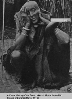 an old black and white photo of a person sitting on the ground talking on a cell phone