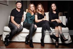 three women and one man sitting on a couch