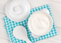 a bowl of yogurt sitting on top of a blue and white checkered cloth