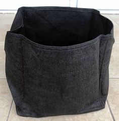 a black bag sitting on top of a tiled floor