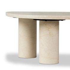 a white marble table with two black bases on each side and an oval base at the top