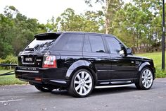 a black range rover parked in a parking lot