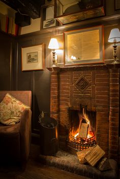 a living room with a fire place and pictures on the wall