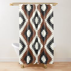 a brown and white shower curtain with an abstract design on the outside, in front of a bathtub