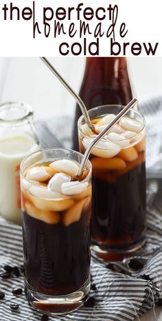 two glasses filled with iced coffee and ice cream on top of a table next to some spoons