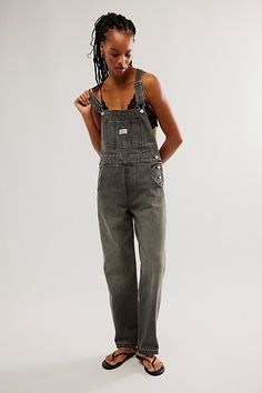 The perfect vintage-inspired overalls from Levi's, this distressed style is featured in a classic bib-and-brace silhouette with front pouch pocket and relaxed, straight leg design. * Adjustable straps * Four pocket design * Side button closures * Logo patch detail at front | Levi's Vintage Overalls at Free People in Black, Size: L Levi’s Overalls, Baggy Overalls, Vintage Overalls, Overall Outfit, 2024 Style, Overalls Women, Leg Design, Vintage Inspired Design, New Wardrobe