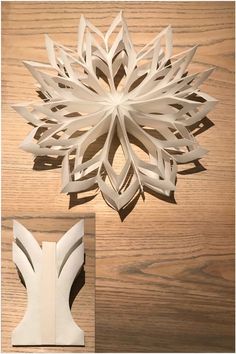 a paper snowflake sitting on top of a wooden table