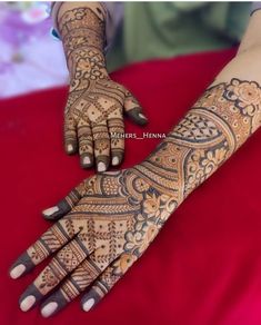 a woman's hand with henna tattoos on it