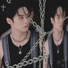 two young men with chains around their necks, one wearing a black shirt and the other in